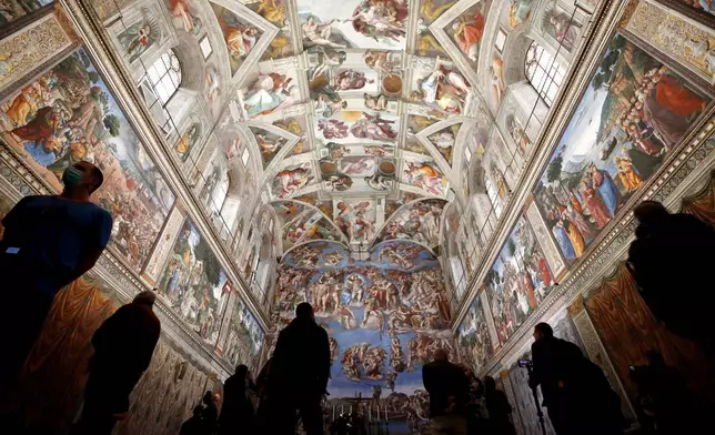 FILE - Visitors admire the Sistine Chapel inside the Vatican Museums on the occasion of the museum's reopening, in Rome, May 3, 2021. (AP Photo/Alessandra Tarantino, file)