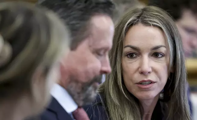 Defendant Karen Read speaks with her attorney Alan Jackson during her murder trial in Norfolk Superior Court in Dedham, Mass., Friday, May 30, 2025. (Mark Stockwell/The Sun Chronicle via AP, Pool)