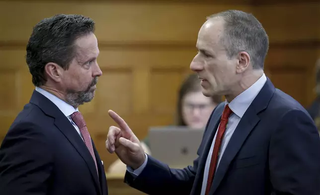 Defense attorneys Alan Jackson, left, and David Yannetti, right, confer before the start of Karen Read's murder trial in Norfolk Superior Court in Dedham, Mass., Friday, May 30, 2025. (Mark Stockwell/The Sun Chronicle via AP, Pool)