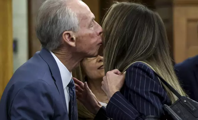 William Read kisses his daughter, Karen Read, before the start of her murder trial in Norfolk Superior Court in Dedham, Mass., Friday, May 30, 2025. (Mark Stockwell/The Sun Chronicle via AP, Pool)