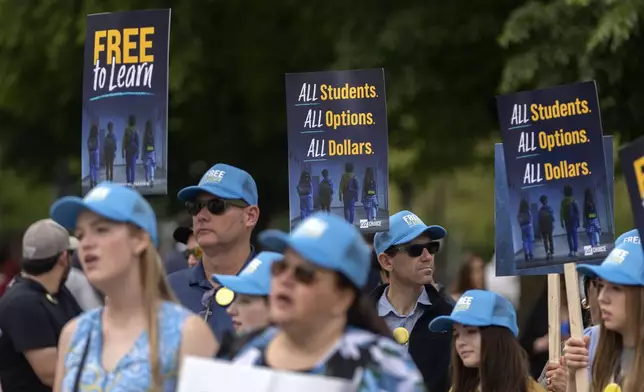 Supporters of charter schools rally outside of the Supreme Court on Wednesday, April 30, 2025, in Washington. (AP Photo/Mark Schiefelbein)