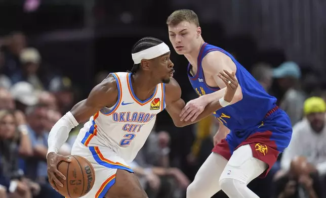 Oklahoma City Thunder guard Shai Gilgeous-Alexander, left, drives past Denver Nuggets guard Christian Braun, right, in the first half of Game 3 in the Western Conference semifinals of the NBA basketball playoffs Friday, May 9, 2025, in Denver. (AP Photo/David Zalubowski)