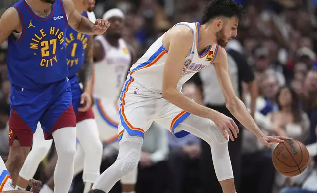Oklahoma City Thunder forward Chet Holmgren, right, collects the ball as Denver Nuggets guard Jamal Murray (27) defends in the first half of Game 3 in the Western Conference semifinals of the NBA basketball playoffs Friday, May 9, 2025, in Denver. (AP Photo/David Zalubowski)