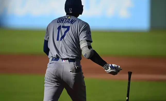 Los Angeles Dodgers' Shohei Ohtani watches his solo home run off Cleveland Guardians starting pitcher Gavin Williams during the first inning of a baseball game, Monday, May 26, 2025, in Cleveland. (AP Photo/David Dermer)