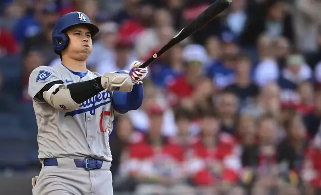Los Angeles Dodgers' Shohei Ohtani reacts after swinging at a pitch during the second inning of a baseball game against the Cleveland Guardians, Monday, May 26, 2025, in Cleveland. (AP Photo/David Dermer)