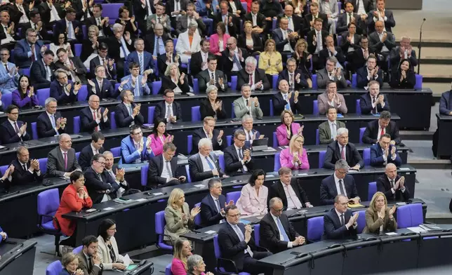 Leader of the Christian Democrats Friedrich Merz, third from right, listens to a debate iahead of a second round of vote at the German federal parliament, Bundestag, at the Reichstag building in Berlin, Germany, Tuesday, May 6, 2025. (AP Photo/Markus Schreiber)