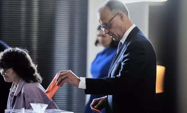 Friedrich Merz casts his vote during the election of a new Chancellor at the parliament Bundestag in Berlin, Tuesday, May 6, 2025. (AP Photo/Markus Schreiber)