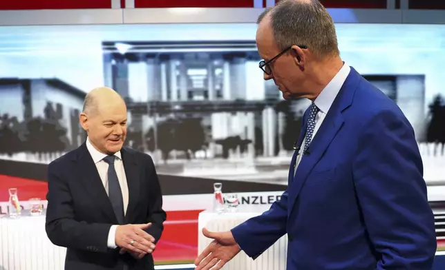 FILE -Olaf Scholz, German Chancellor of the Social Democratic Party (SPD), left, and Friedrich Merz, right, leader of the Christian Democratic Union (CDU), are pictured in tv studio ahead of a debate in Berlin, Germany, Feb. 19, 2025. (Fabrizio Bensch/Pool Photo via AP, File)