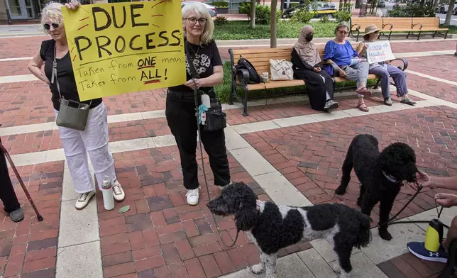 Dana Gardiner, left, and her daughter Andrea Cale, of Alexandria, Va., rally in support of Georgetown University scholar Badar Khan Suri, in opposition to his arrest and detention, before a news conference following his hearing outside of the courthouse, at the Federal District Court for the Eastern District of Virginia, in Alexandria, Va., Thursday, May 1, 2025. (AP Photo/Jacquelyn Martin)