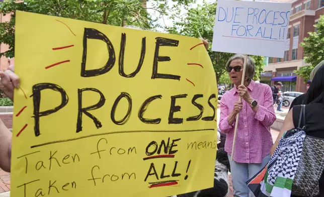 Maxine Columbia, right, of Alexandria, Va., rallies in support of Badar Khan Suri and in opposition to the Georgetown University scholar's arrest and detention, outside his courthouse hearing, in Alexandria, Va., Thursday, May 1, 2025. (AP Photo/Jacquelyn Martin)