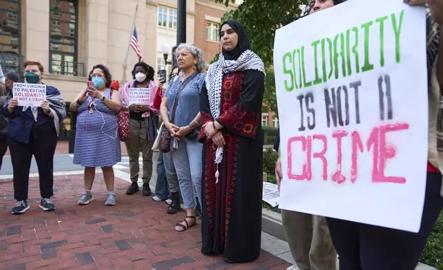 Mapheze Saleh, at center, wife of arrested and detained Georgetown University scholar Badar Khan Suri, attends a news conference following her husband's hearing at the Federal District Court for the Eastern District of Virginia, in Alexandria, Va., Thursday, May 1, 2025. (AP Photo/Jacquelyn Martin)