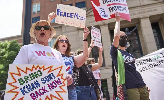 Anita Martineau, of Arlington, Va., left, and her daughter Marisa Martineau, center, rally in support of Georgetown University scholar Badar Khan Suri, in opposition to his arrest and detention, before a news conference following his hearing outside of the courthouse, at the Federal District Court for the Eastern District of Virginia, in Alexandria, Va., Thursday, May 1, 2025. (AP Photo/Jacquelyn Martin)