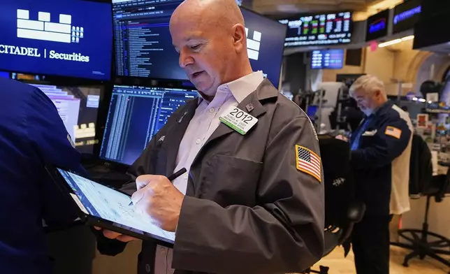 Trader Patrick Casey, left, works on the floor of the New York Stock Exchange, Monday, May 5, 2025. (AP Photo/Richard Drew)