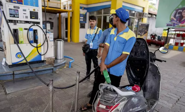An Indian man fills petrol in a two wheeler at a fuel pump in Prayagraj, in the northern Indian state of Uttar Pradesh, Monday, May 5, 2025. (AP Photo/Rajesh Kumar Singh)