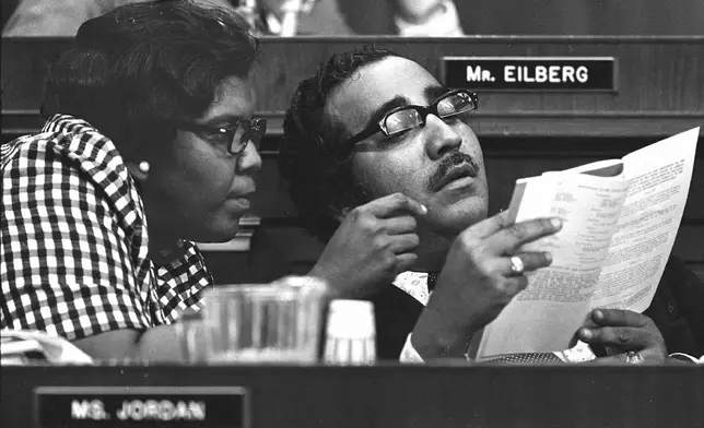 FILE - In this July 26, 1974 file photo, Reps. Charles Rangel, D-N.Y., and Barbara Jordan, D-Tex., left, look over a copy of the Constitution during a House Judiciary Committee debate on articles of impeachment for President Richard Nixon in Washington, D.C. (AP Photo/File)