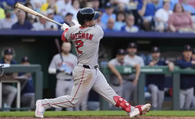 Boston Red Sox's Alex Bregman watches his RBI single during the fifth inning of a baseball game against the Kansas City Royals, Saturday, May 10, 2025, in Kansas City, Mo. (AP Photo/Charlie Riedel)