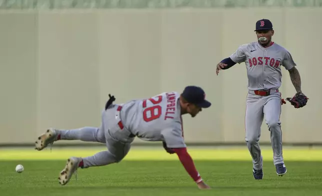 Boston Red Sox second baseman Kristian Campbell (28) and center fielder Ceddanne Rafaela chase after an RBI single bit by Kansas City Royals' Mark Canha during the third inning of a baseball game Saturday, May 10, 2025, in Kansas City, Mo. (AP Photo/Charlie Riedel)