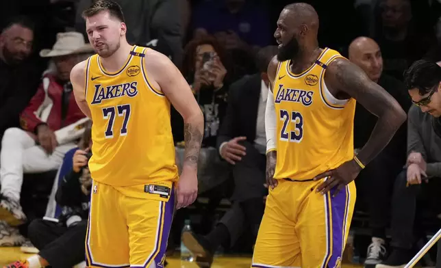 Los Angeles Lakers guard Luka Doncic (77) walks off the court after an injury during the first half in Game 5 of an NBA basketball first-round playoff series against the Minnesota Timberwolves, Wednesday, April 30, 2025, in Los Angeles. (AP Photo/Mark J. Terrill)