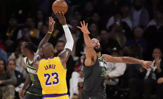 Los Angeles Lakers forward LeBron James (23) shoots over Minnesota Timberwolves center Rudy Gobert during the second half in Game 5 of an NBA basketball first-round playoff series Wednesday, April 30, 2025, in Los Angeles. (AP Photo/Mark J. Terrill)