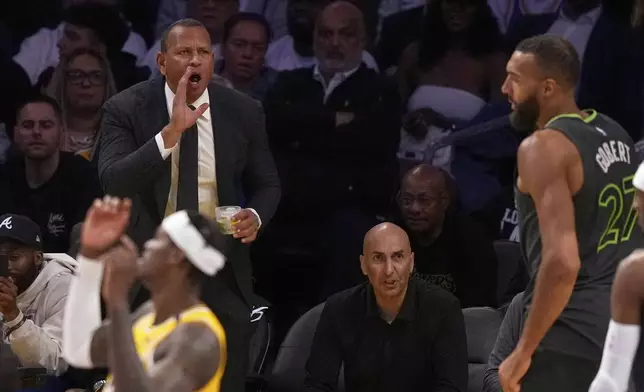 Minnesota Timberwolves co-owner Alex Rodriguez yells to center Rudy Gobert after he scored during the second half in Game 5 of an NBA basketball first-round playoff series against the Los Angeles Lakers, Wednesday, April 30, 2025, in Los Angeles. (AP Photo/Mark J. Terrill)