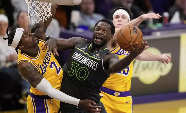 Minnesota Timberwolves forward Julius Randle (30) drives to the basket as Los Angeles Lakers forward Jarred Vanderbilt (2) defends during the first half in Game 5 of an NBA basketball first-round playoff series Wednesday, April 30, 2025, in Los Angeles. (AP Photo/Mark J. Terrill)
