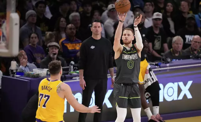Minnesota Timberwolves guard Donte DiVincenzo (0) shoots over Los Angeles Lakers guard Luka Doncic (77) during the first half in Game 5 of an NBA basketball first-round playoff series Wednesday, April 30, 2025, in Los Angeles. (AP Photo/Mark J. Terrill)