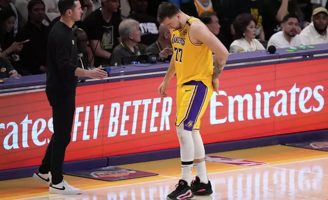 Los Angeles Lakers guard Luka Doncic (77) walks off the court after an injury during the first half in Game 5 of an NBA basketball first-round playoff series against the Minnesota Timberwolves, Wednesday, April 30, 2025, in Los Angeles. (AP Photo/Mark J. Terrill)
