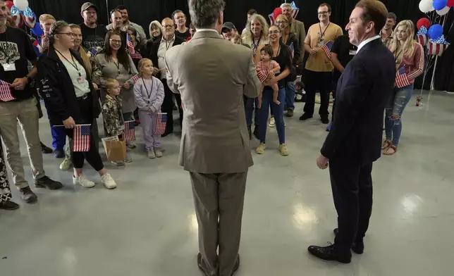 Deputy Secretary of State Christopher Landau, left, greets Afrikaner refugees from South Africa, Monday, May 12, 2025, at Dulles International Airport in Dulles, Va. (AP Photo/Julia Demaree Nikhinson)