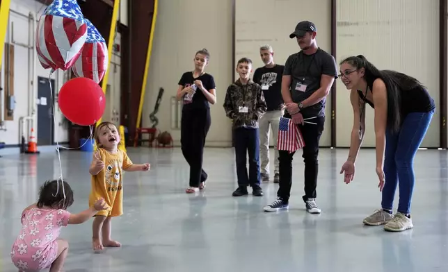 Young Afrikaner refugees from South Africa play with balloons as they arrive with their families, Monday, May 12, 2025, at Dulles International Airport in Dulles, Va. (AP Photo/Julia Demaree Nikhinson)