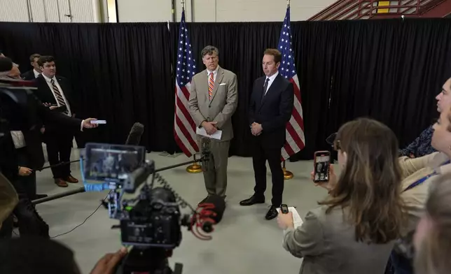 Deputy Secretary of State Christopher Landau, left, greets Afrikaner refugees from South Africa, Monday, May 12, 2025, at Dulles International Airport in Dulles, Va. (AP Photo/Julia Demaree Nikhinson)