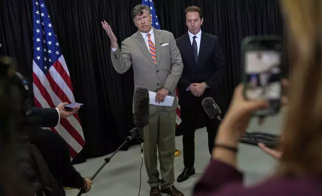 Deputy Secretary of State Christopher Landau, left, greets Afrikaner refugees from South Africa, Monday, May 12, 2025, at Dulles International Airport in Dulles, Va. (AP Photo/Julia Demaree Nikhinson)
