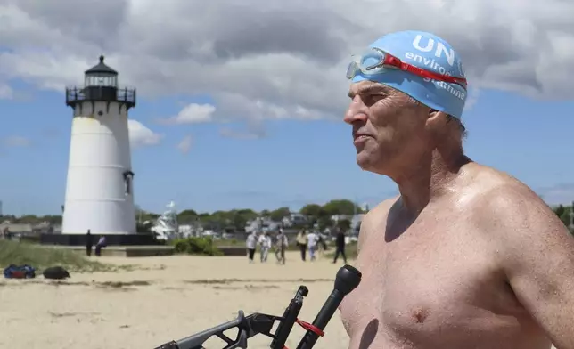 British South African endurance swimmer Lewis Pugh speaks with press directly after completing his 12-day 62-mile (100 kilometer) swim around the island of Martha's Vineyard, Mass., ahead of the 50th anniversary of the first blockbuster film "Jaws"' release, Monday, May 26, 2025. (AP Photo/Leah Willingham)
