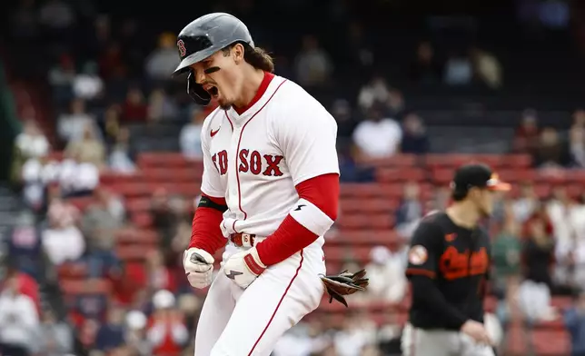 Boston Red Sox's Jarren Duran shouts after hitting an RBI single against the Baltimore Orioles during the sixth inning in the first baseball game of a doubleheader Friday, May 23, 2025, at Fenway Park in Boston. (AP Photo/Winslow Townson)