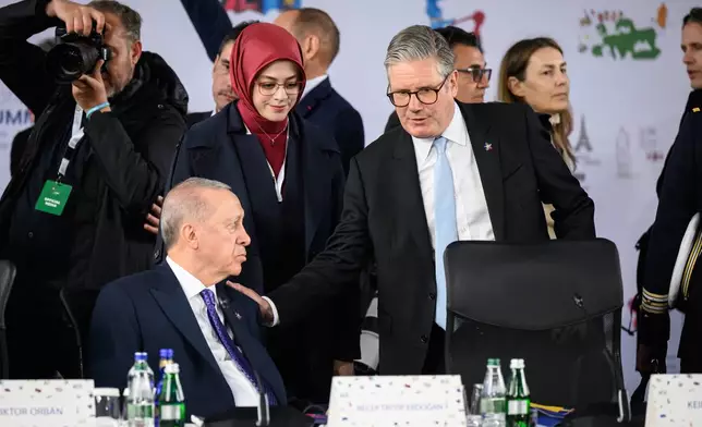Britain's Prime Minister Keir Starmer, right, and Turkey's President Recep Erdogan attend a plenary meeting at the beginning of a summit where the leaders of 47 European countries and organizations will discuss security, defense and democratic standards, in Tirana, Albania, Friday, May 16, 2025. (Leon Neal/Pool via AP)