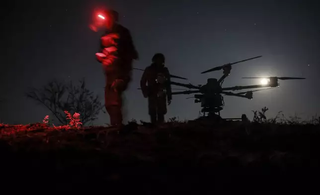 In this photo provided by Ukraine's 24th Mechanized Brigade press service, servicemen prepare the drone "Kazhan" that delivers supply and carry heavy bombs, on the front line near Chasiv Yar town, in Donetsk region, Ukraine, Thursday, May 15, 2025. (Oleg Petrasiuk/Ukraine's 24th Mechanized Brigade via AP)