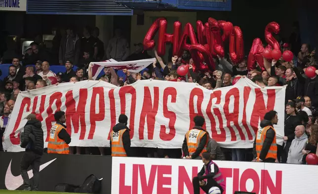 Liverpool fans cheer for their team prior to the English Premier League soccer match between Chelsea and Liverpool at Stamford Bridge stadium in London, Sunday, May 4, 2025. (AP Photo/Kin Cheung)