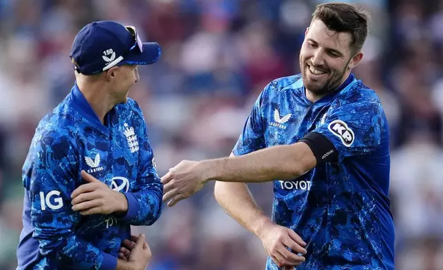 England's Jamie Overton, right, celebrates after taking the wicket of West Indies' Matthew Forde during the first One Day International match between England and West Indies at Edgbaston, Birmingham, England, Thursday May 29, 2025. (Nick Potts/PA via AP)