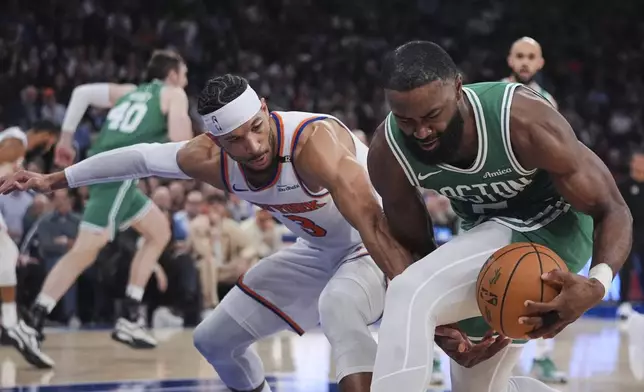 Boston Celtics' Jaylen Brown (7) fights for control of the ball with New York Knicks' Josh Hart (3) during the first half of Game 6 in the Eastern Conference semifinals of the NBA basketball playoffs Friday, May 16, 2025, in New York. (AP Photo/Frank Franklin II)