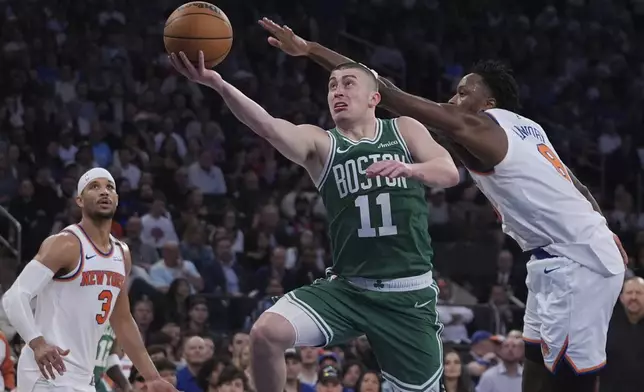 Boston Celtics' Payton Pritchard (11) drives past New York Knicks' OG Anunoby (8) during the second half of Game 6 in the Eastern Conference semifinals of the NBA basketball playoffs Friday, May 16, 2025, in New York. (AP Photo/Frank Franklin II)