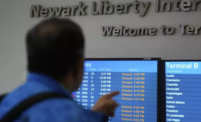 A display shows the status of flights at Newark Liberty International Airport in Newark, N.J., Monday, May 5, 2025. (AP Photo/Seth Wenig)