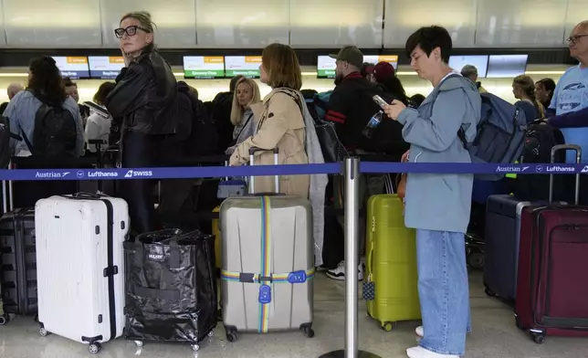 Travelers wait to check into their flights at Newark Liberty International Airport in Newark, N.J., Monday, May 5, 2025. (AP Photo/Seth Wenig)