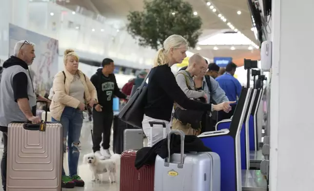 Travelers check into their flights at Newark Liberty International Airport in Newark, N.J., Monday, May 5, 2025. (AP Photo/Seth Wenig)