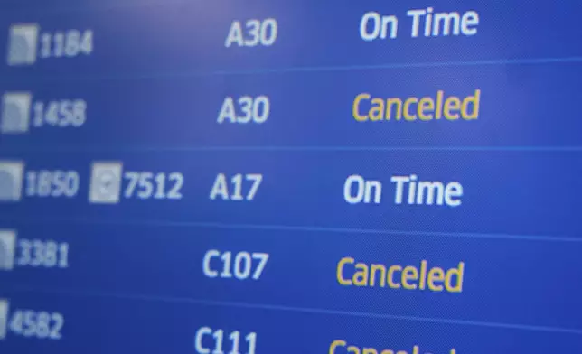 A display shows the status of flights at Newark Liberty International Airport in Newark, N.J., Monday, May 5, 2025. (AP Photo/Seth Wenig)