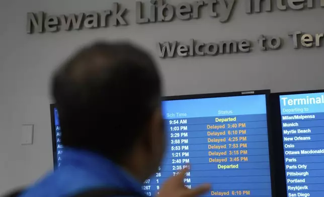 A display shows the status of flights at Newark Liberty International Airport in Newark, N.J., Monday, May 5, 2025. (AP Photo/Seth Wenig)
