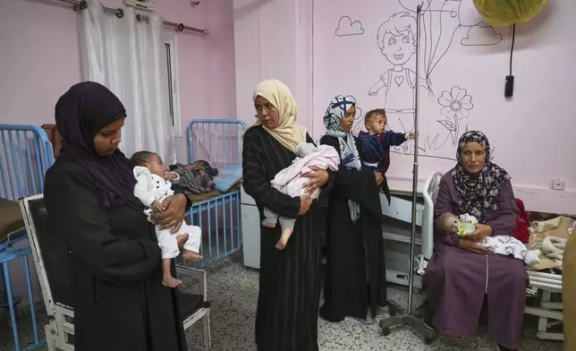 Palestinian women care for their babies at the malnutrition clinic in Nasser hospital, Khan Younis, Gaza Strip, Thursday, May 1, 2025. (AP Photo/Abdel Kareem Hana)
