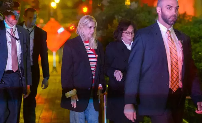Attorney General Pam Bondi, center, and U.S. Attorney for the District of Columbia Jeanine Pirro, second right, walk to cars as law enforcement work the scene after two staff members of the Israeli Embassy in Washington were shot and killed outside the Capital Jewish Museum, Thursday, May 22, 2025, in Washington. (AP Photo/Rod Lamkey, Jr.)