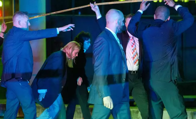 Attorney General Pam Bondi, from second left, and U.S. Attorney for the District of Columbia Jeanine Pirro walk to cars as law enforcement work the scene after two staff members of the Israeli Embassy in Washington were shot and killed outside the Capital Jewish Museum, Thursday, May 22, 2025, in Washington. (AP Photo/Rod Lamkey, Jr.)