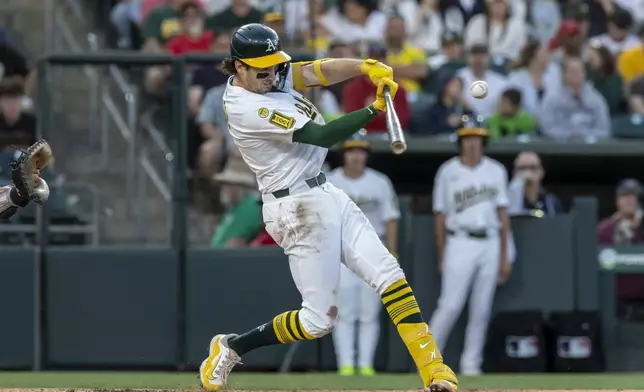 Athletics' Jacob Wilson hits an RBI single during the second inning of a baseball game against the Philadelphia Phillies Saturday, May 24, 2025, in West Sacramento, Calif. (AP Photo/Sara Nevis)