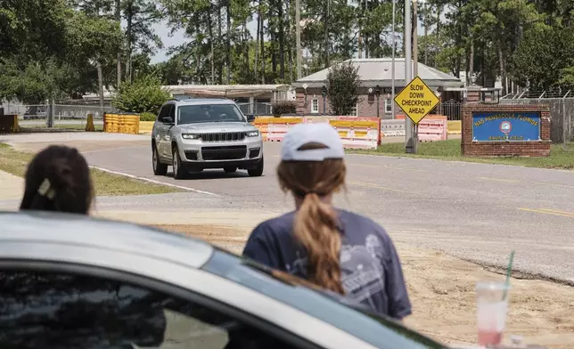 Kelsey Heath, left, and Emma Touchstone, 17, wait for reality television star Todd Chrisley to walk out of the Federal Prison Camp, Wednesday, May 28, 2025, in Pensacola, Fla. (AP Photo/Dan Anderson)