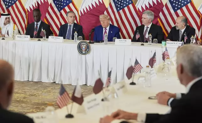 President Donald Trump speaks, seated between Kelly Ortberg President and CEO of Boeing, left, and Larry Culp, CEO of GE Aerospace during a business roundtable, Thursday, May 15, 2025, in Doha, Qatar. (AP Photo/Alex Brandon)